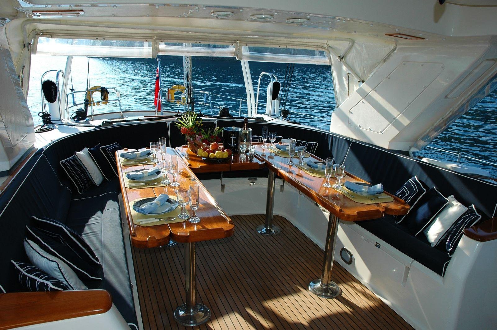 Navy upholstered cockpit bench squabs and cushions around a table on a launch – cabin and cockpit upholstery costs in New Zealand