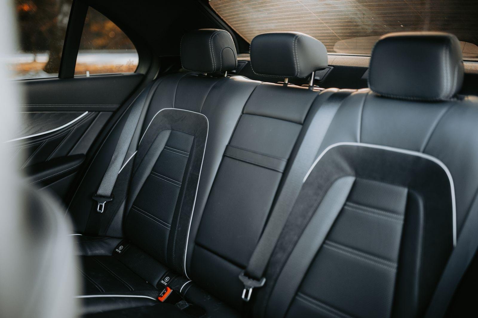 Black leather rear car seats in a modern vehicle interior – automotive upholstery and car seat repair on Auckland's North Shore