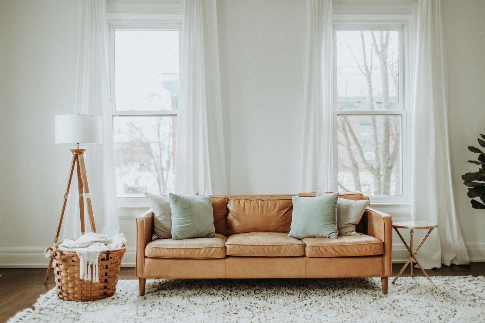 Tan leather three-seater sofa in a bright living room – what couch repair and reupholstery costs in Auckland