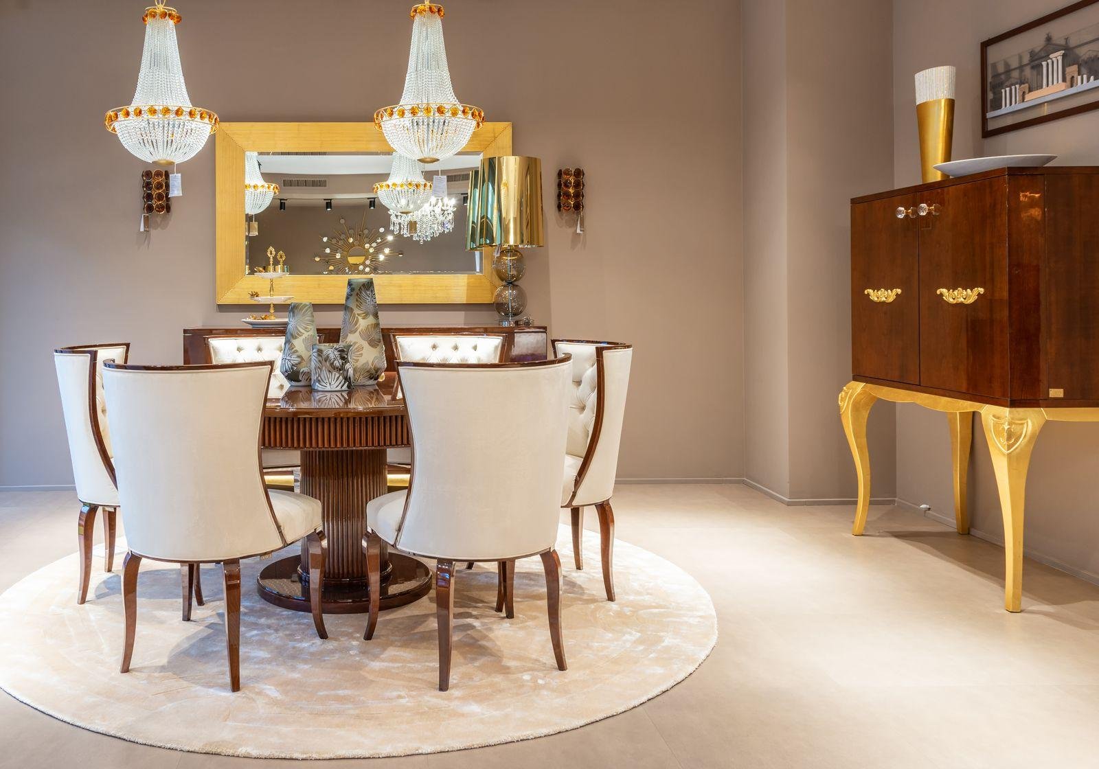 Set of white upholstered dining chairs around a round table – dining chair reupholstery costs in Auckland
