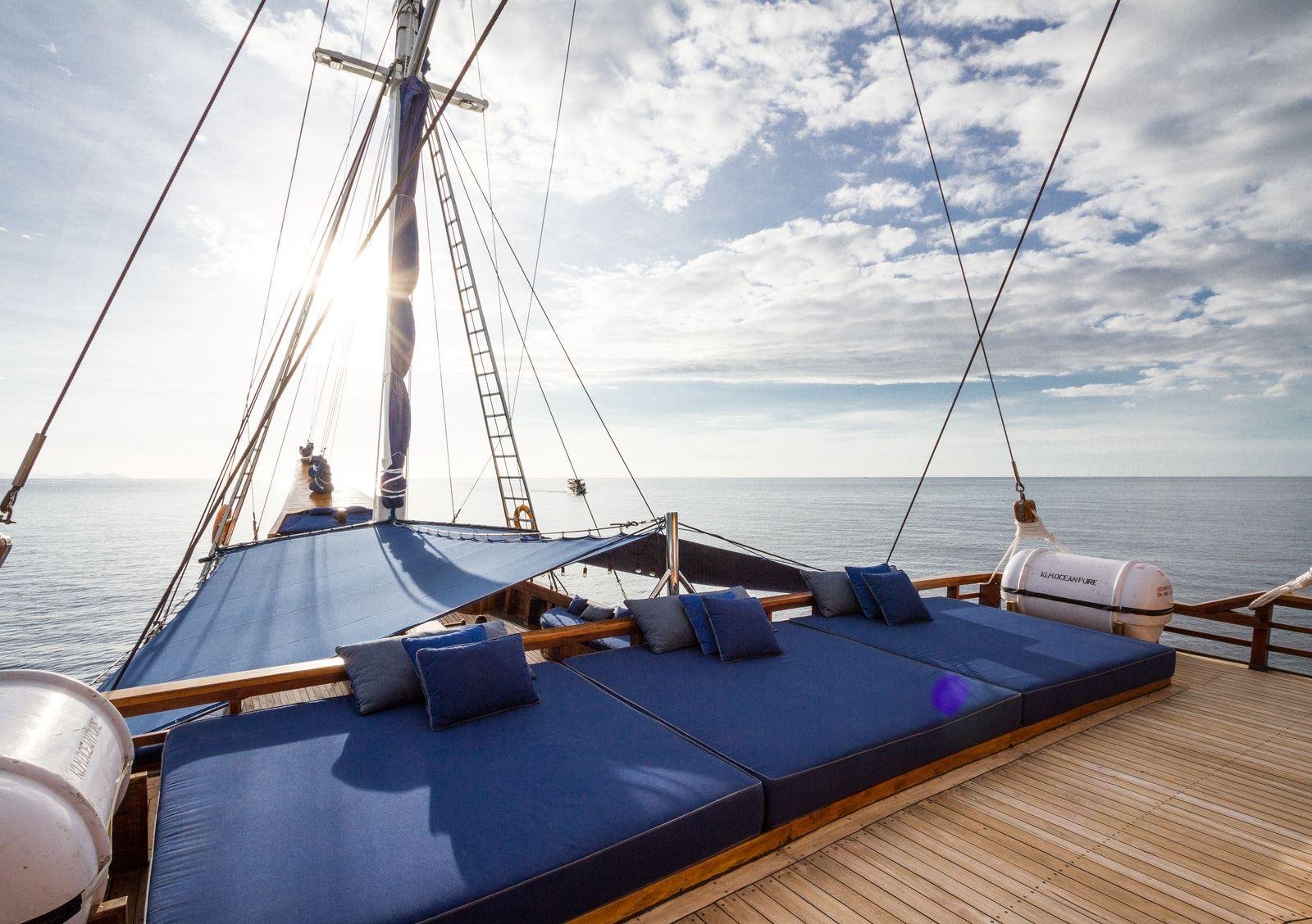 Blue marine-grade deck cushions on a sailboat in sunlight – marine upholstery and boat squab costs in Auckland